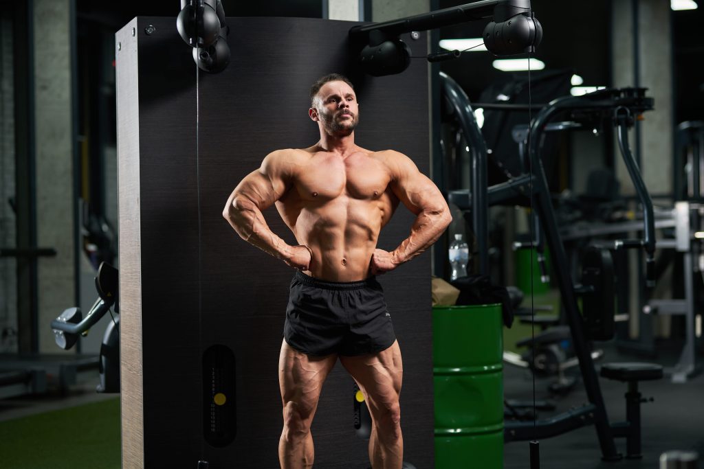 Why Bodybuilders Take DIM: The Lowdown on Diindolylmethane in Bodybuilding 1 handsome bodybuilder performing front lat spread pose1