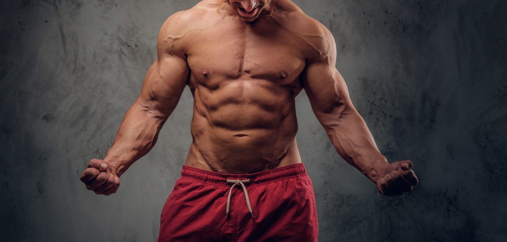 What Are 5 Steroids You'll Probably Need to Know About 3 muscular man with nice muscules is posing photographer dark photo studio
